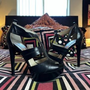 Black leather Michael by Michael Kors “Berkeley” ankle T-strap heels